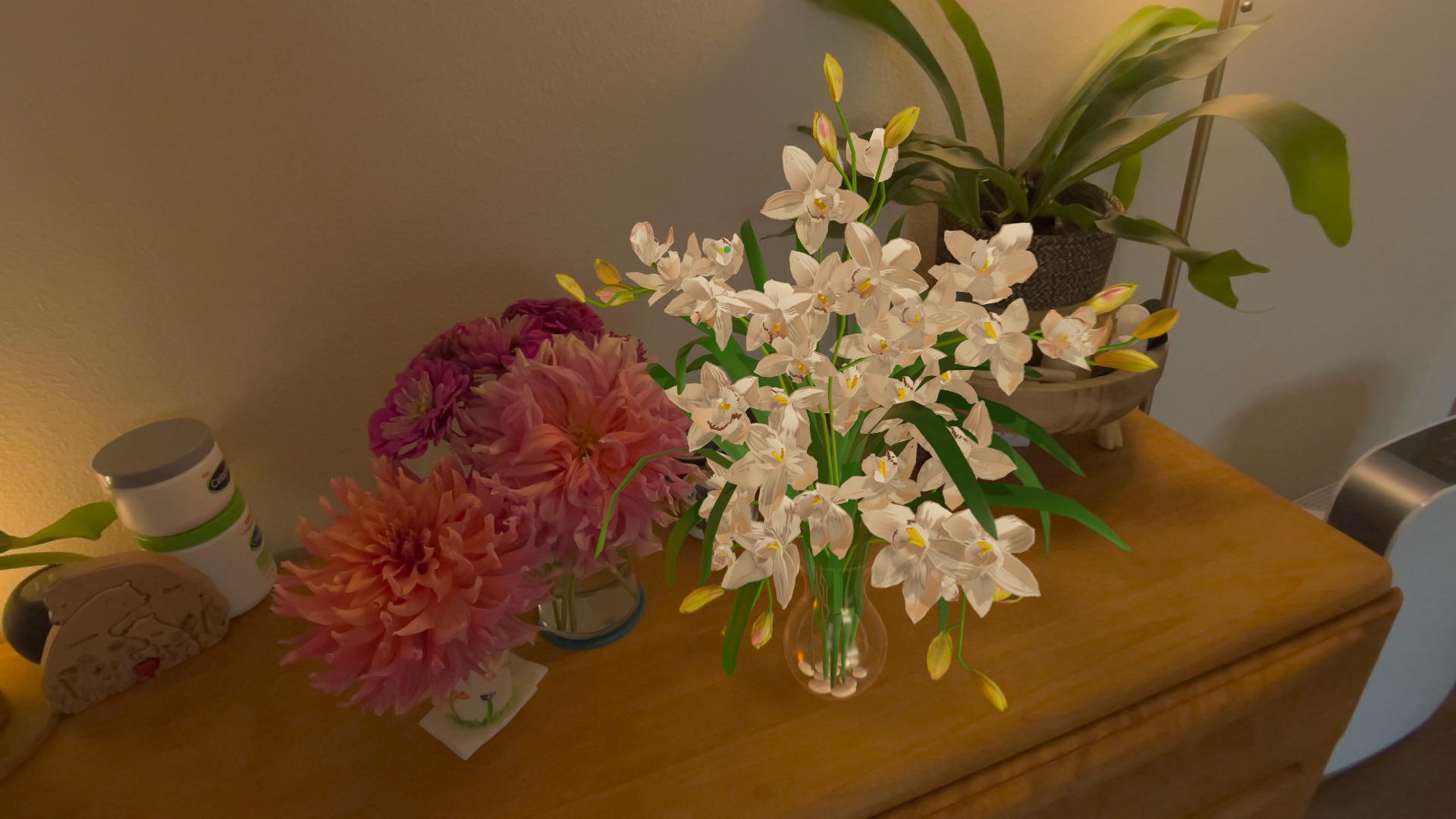 Dahlias and orchids arranged on a real sideboard